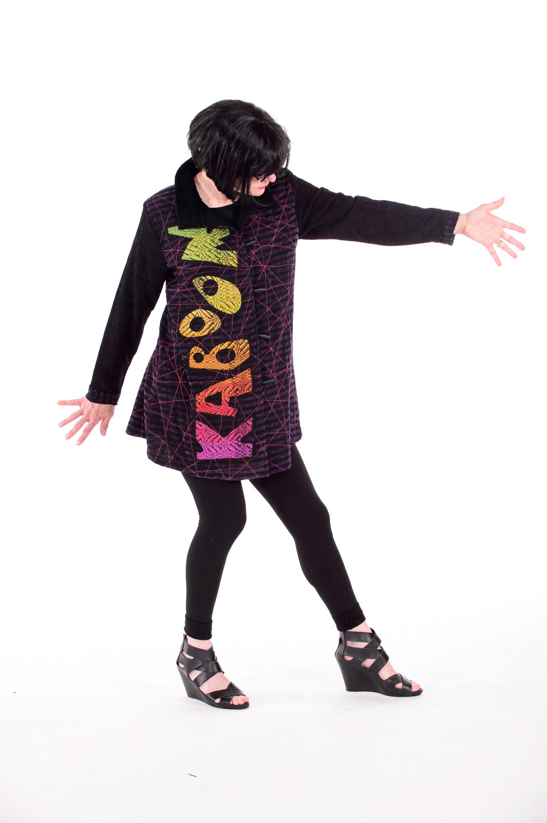 KABOOM JACKET of silk, merino wool, bamboo, rayon, cotton, letters cut out of variegated handwoven fabric and appliquéd, 2015. Model: Tamara Chapman. Photograph by Bruce Preston.