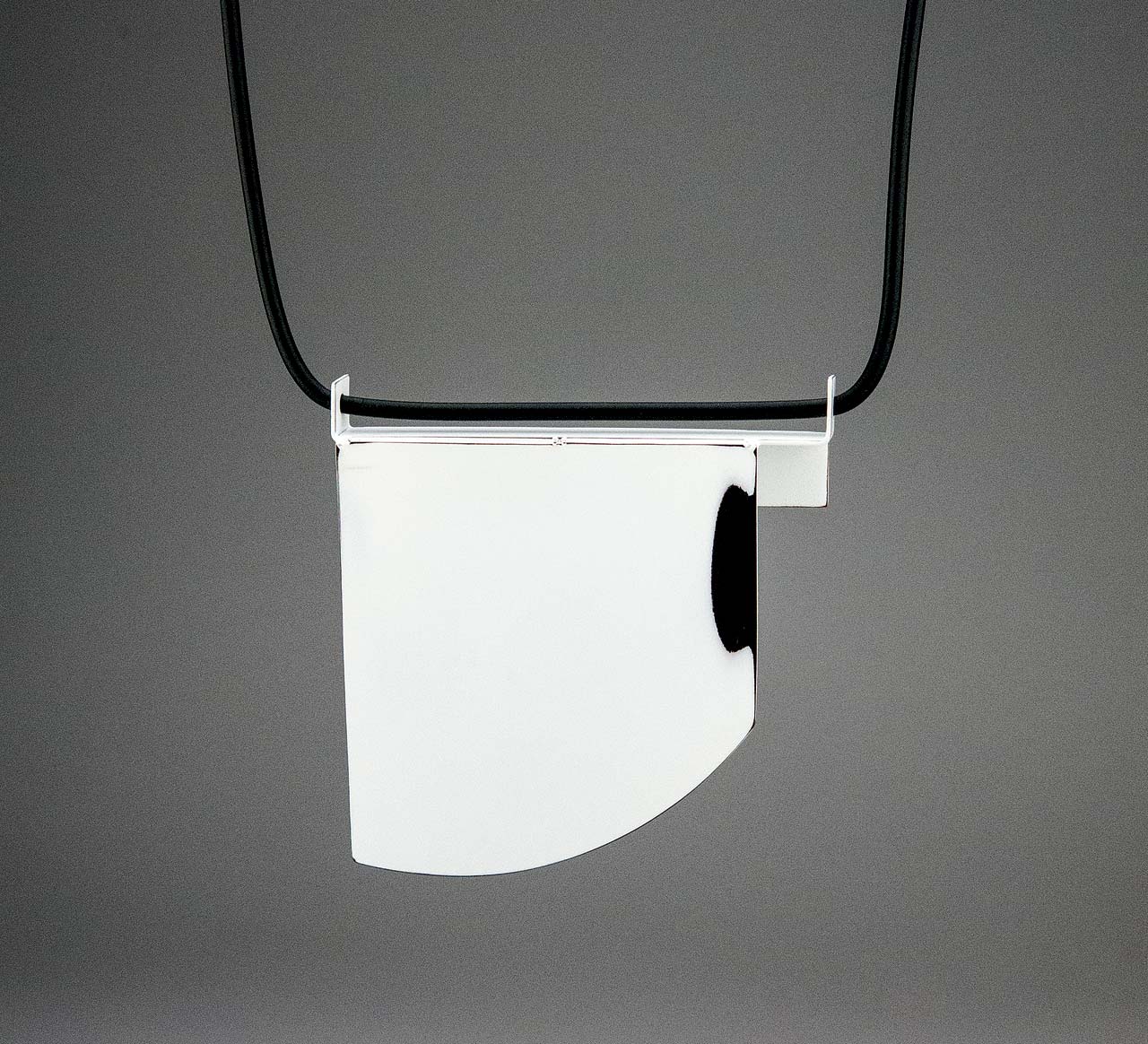 FOLD 1 NECKLACE by Jim Bové of sterling silver, rubber cord, industrial auto paint on copper, 10.8 x 10.16 x 1.27 centimeters, 2015. Photograph by Jim Bové.