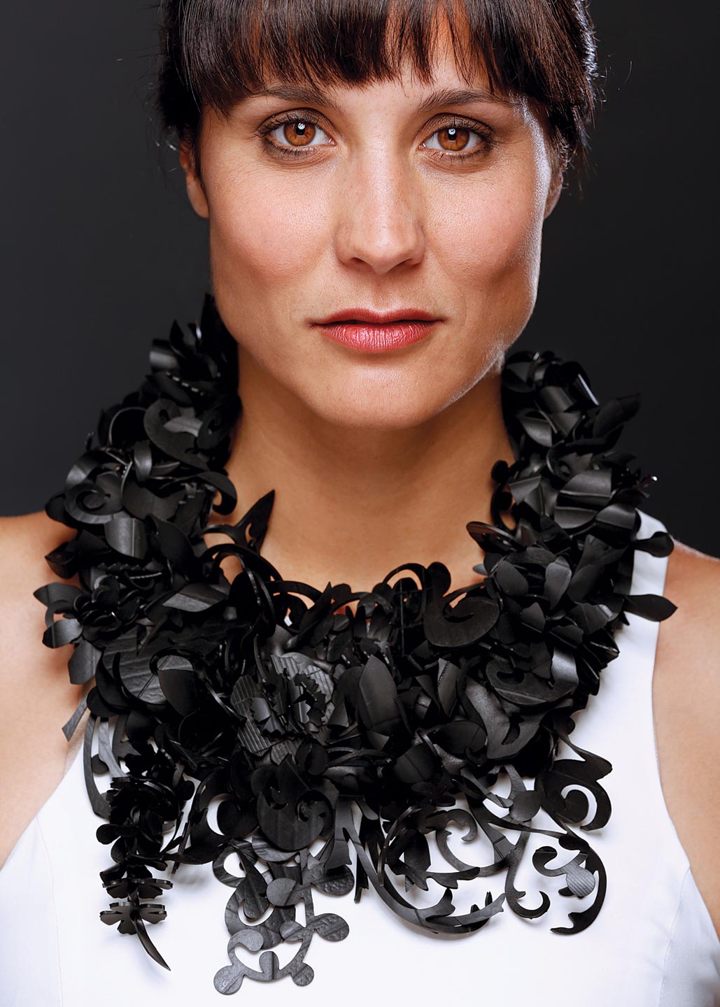 KATHLEEN NOWAK TUCCI. Secret Garden Necklace of recycled motorcycle and bicycle inner tubes and Nespresso coffee capsules, Second Place Alternative Metals/Materials.