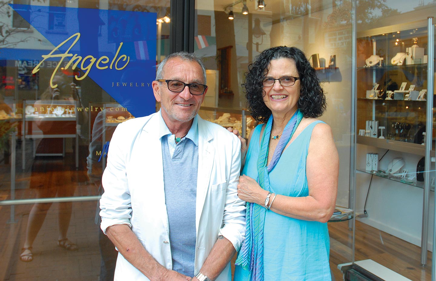 LEE MARRACCINI AND PAM PERUGI MARRACCINI standing in front of their store, Angelo Jewelry.