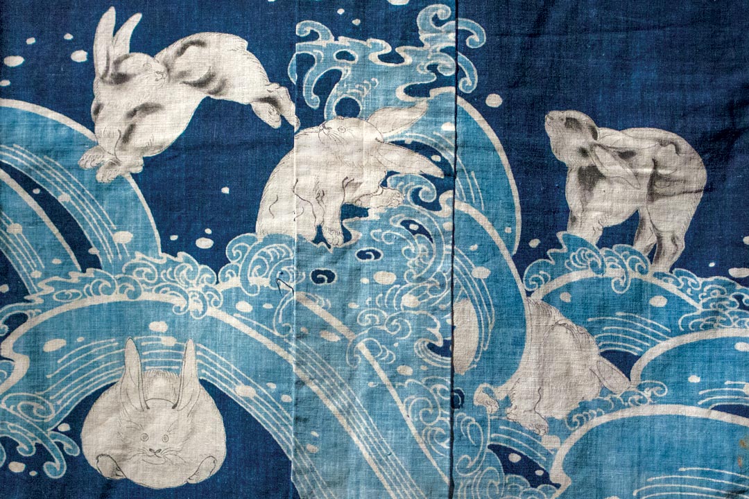 JAPANESE COVERLET (detail) in kimono form (yogi), of cotton cloth with freehand paste-resist decoration (tsutsugaki). Gift of Virginia and Bagley Wright.