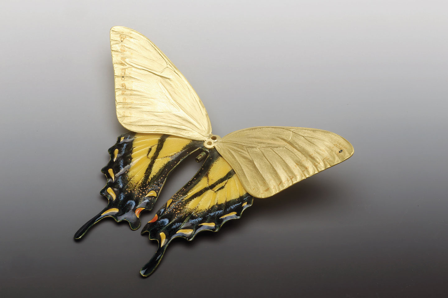 WESTERN TIGER SWALLOWTAIL BROOCH IN PROGRESS, with lower wings enameled, upper still bare gold, all cold-joined, 9.3 cm wingspan; actual butterfly was collected in southern California. Compare this to experimental work on facing page, of another swallowtail butterfly. His enameled jewelry is twenty karat gold, but findings are eighteen karat.