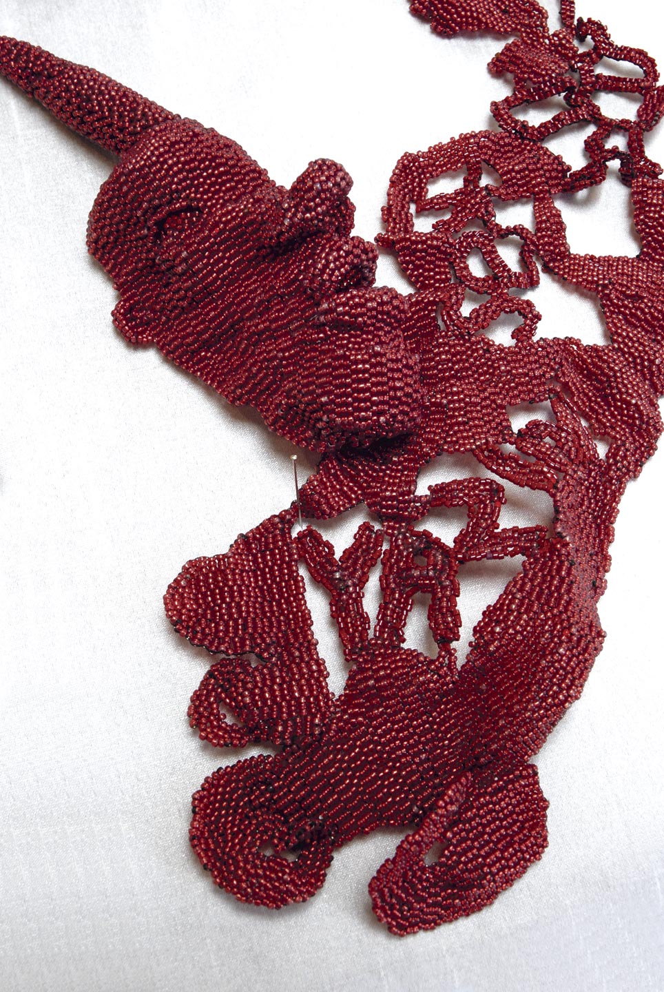 YAZIDI SEX SLAVE NECKLACE by Joyce Scott, 2016. Photograph by Madison Metro.
