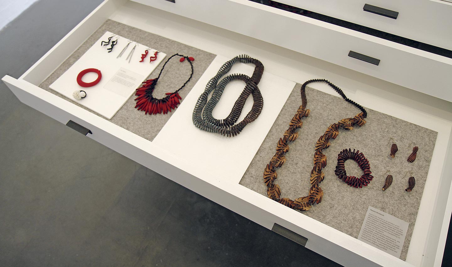 JEWELRY BY TZURI GUETA AND NAOMI MCINTOSH. Gueta creates jewelry from silicone-Injected lace. Mcintosh uses CAD to create designs on a sheet of wood, which she then removes via laser-cutting. Photograph by Robert K. Liu/Ornament Magazine.