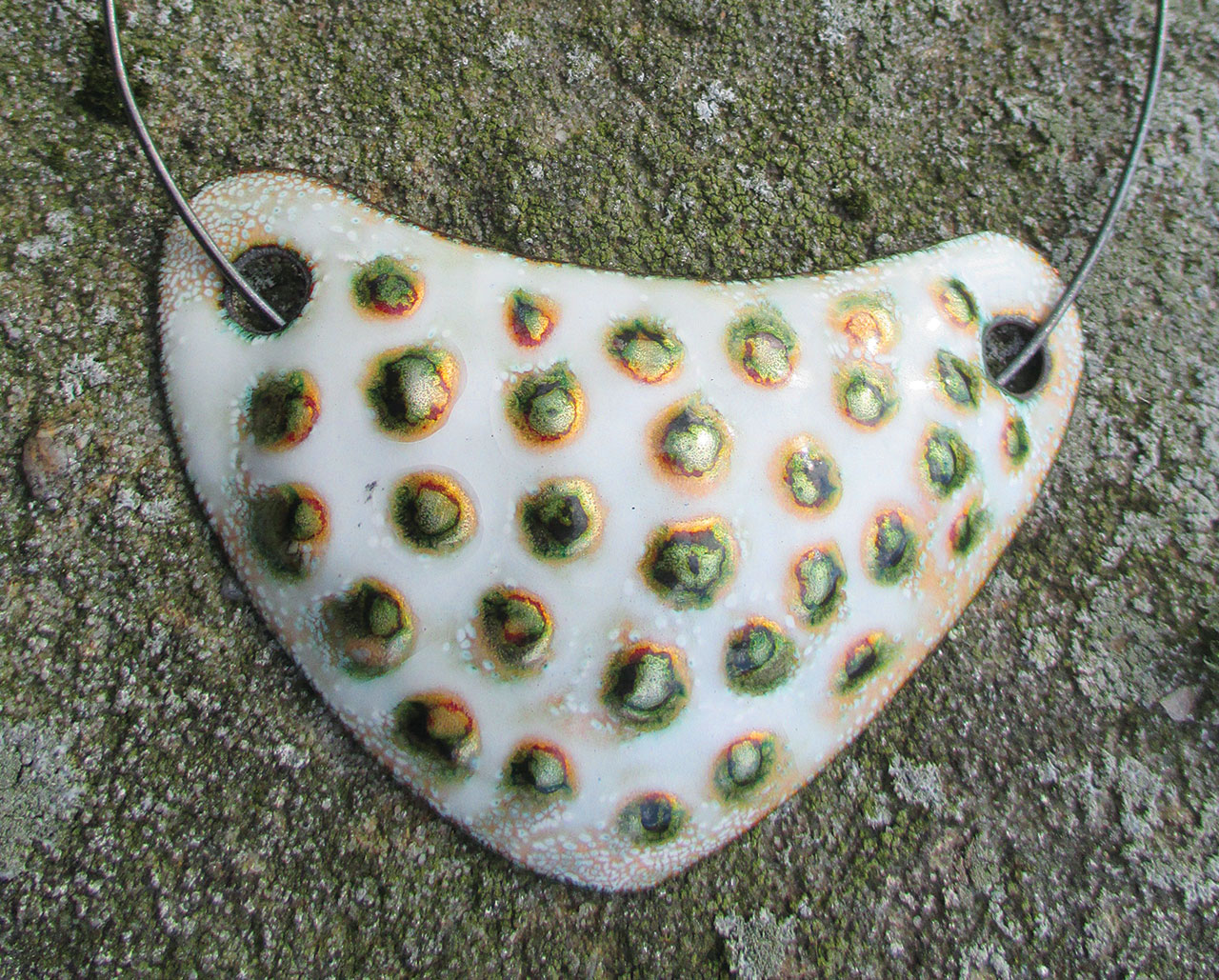 NECKLACE with metal choker. Shield is 6.03 x 9.21 centimeters. Jewelry is enamel on copper, circa 1950-1957. Collection of Patricia Antonia Collier. Photograph by Ashley Callahan.
