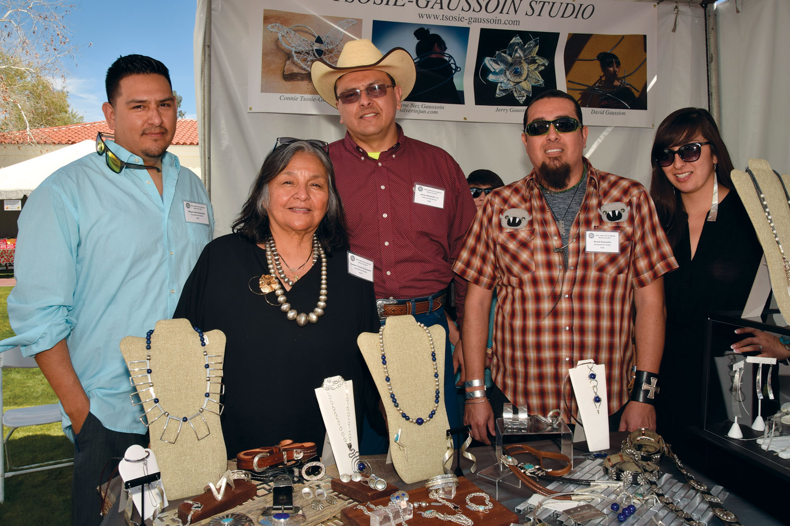THE TSOSIE-GAUSSOIN FAMILY. (left to right) Wayne Nez Gaussoin, Connie Tsosie-Gaussoin, Jerry E. Gaussoin Jr., David Gaussoin, Tazbah Gaussoin, showing at the Heard Museum Guild Indian Fair and Market, March 2017. Photograph by Margie Zebell-Parrish.