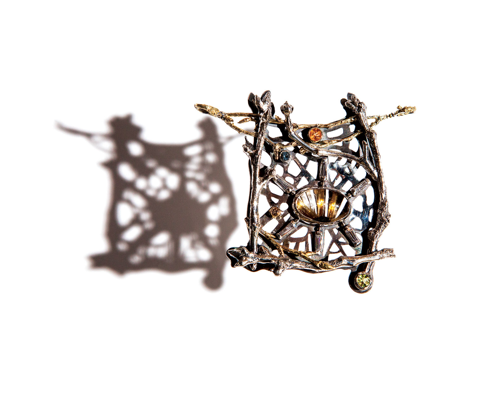 SUNLIGHT IN THE TREES BROOCH/PENDANT of sterling silver, fourteen and eighteen karat gold, cubic zirconia, peridot, aquamarine, garnet spessartite, 6.4 x 5.7 x 1.3 centimeters, 2017. Photograph by Dede Giddens.