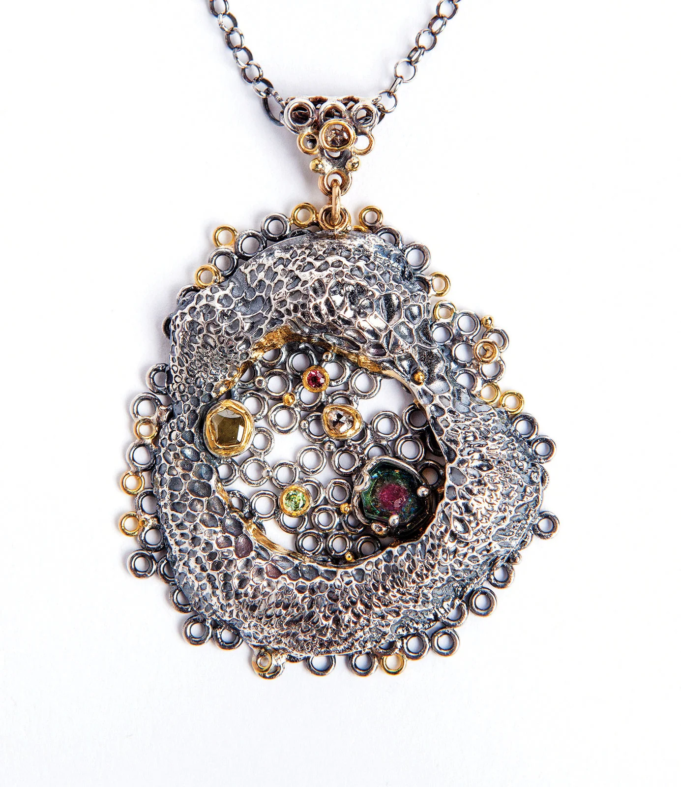 PROLIFERATION PENDANT of argentium sterling silver, fourteen, eighteen and twenty-two karat gold, spinel, 6.4 x 5.1 x 1.3 centimeters, 2016. Photograph by Dede Giddens.