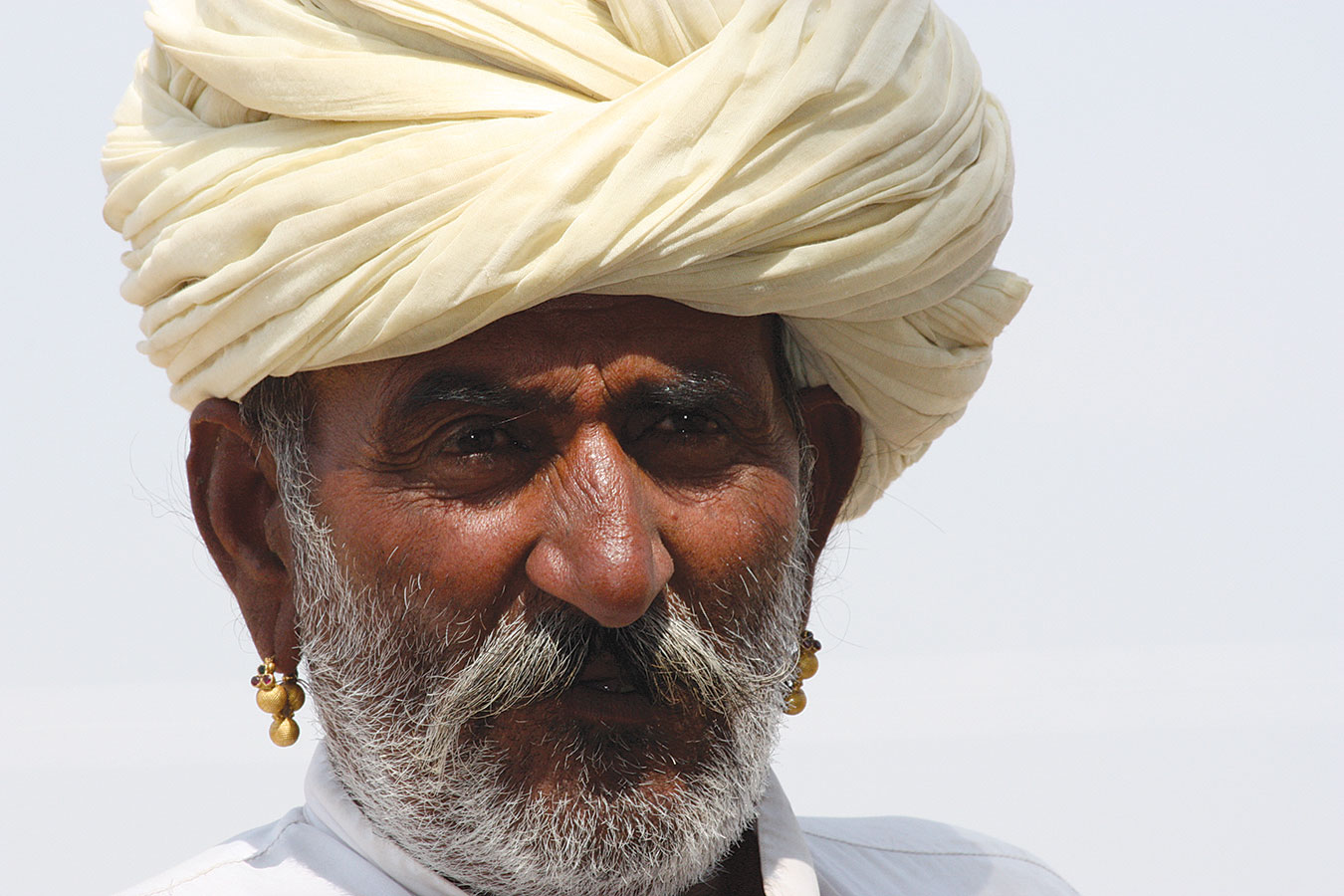 A FARMER FROM THE GUJJAR COMMUNITY wears a pair of gokhru earrings, Pushkar, 2009. Photograph by Thomas K. Seligman. 