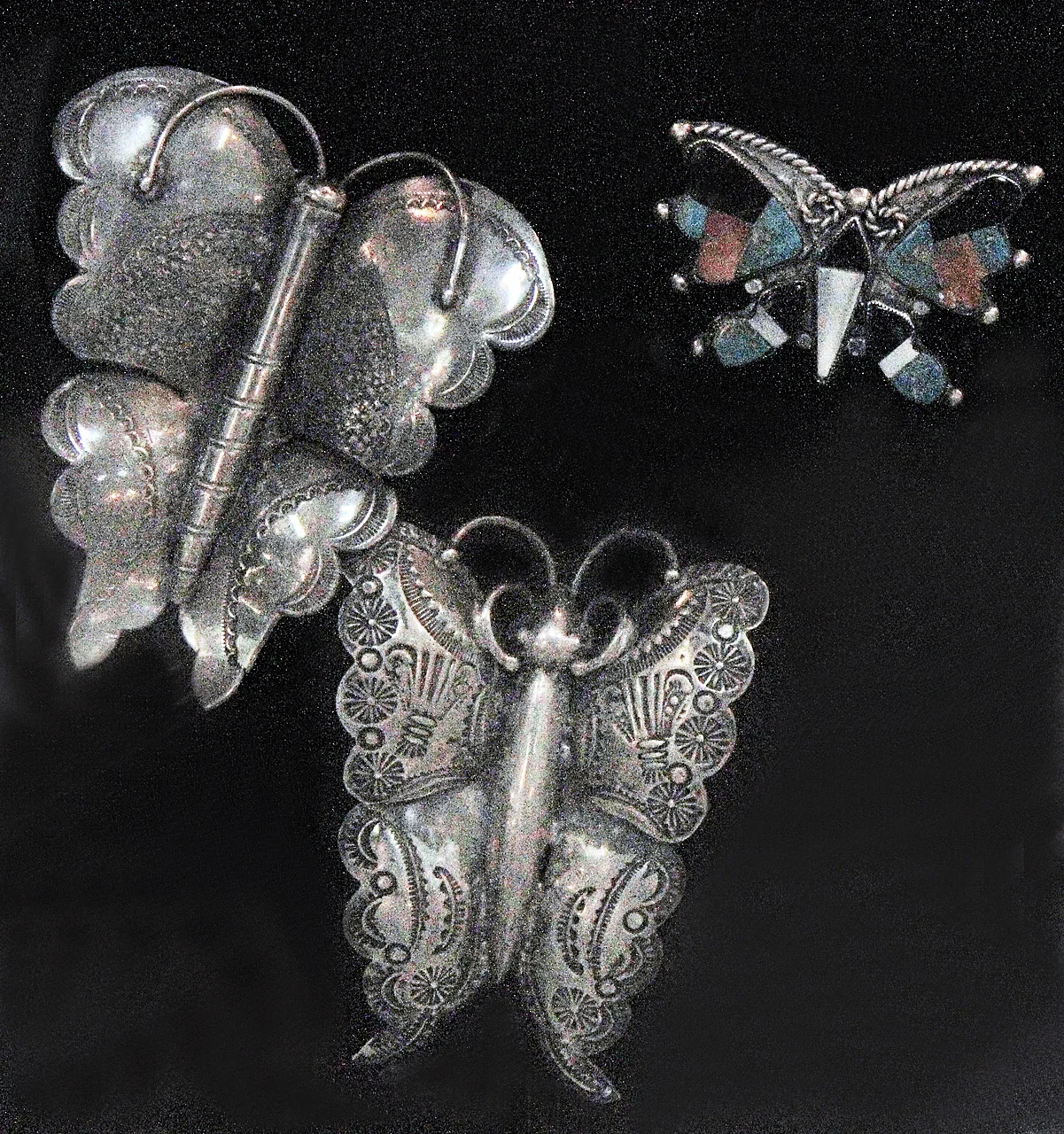 Hopi or Navajo butterfly pins, of silver, with stampwork, probably date from the 1930s to 1940s. An example is in the Doneghy Collection at the MIA, Minneapolis. The small inlay butterfly is most likely Zuni.