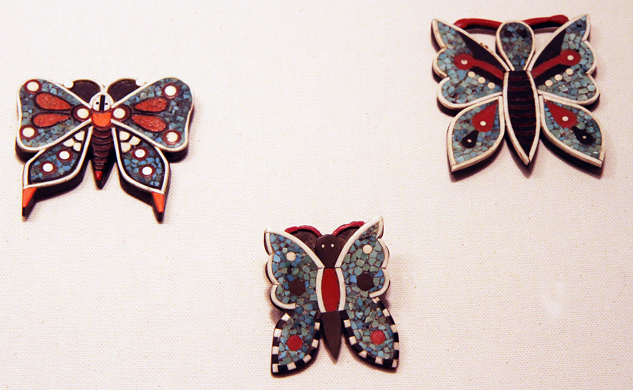 Butterfly pins, probably from Santa Domingo Pueblo and possibly made from late 1920s to 1950s. Often called Depression jewelry, as they were made from non-precious or low-cost materials like phonograph records/battery cases, other plastics and gypsum, as well as turquoise. Because we walked through the Philips galleries rather quickly, due to the volume of material, I did not have time to record the captions on the displays. These bear some similarity to polymer butterflies made in recent years. Courtesy of the Wheelwright Museum, as are the last two images.