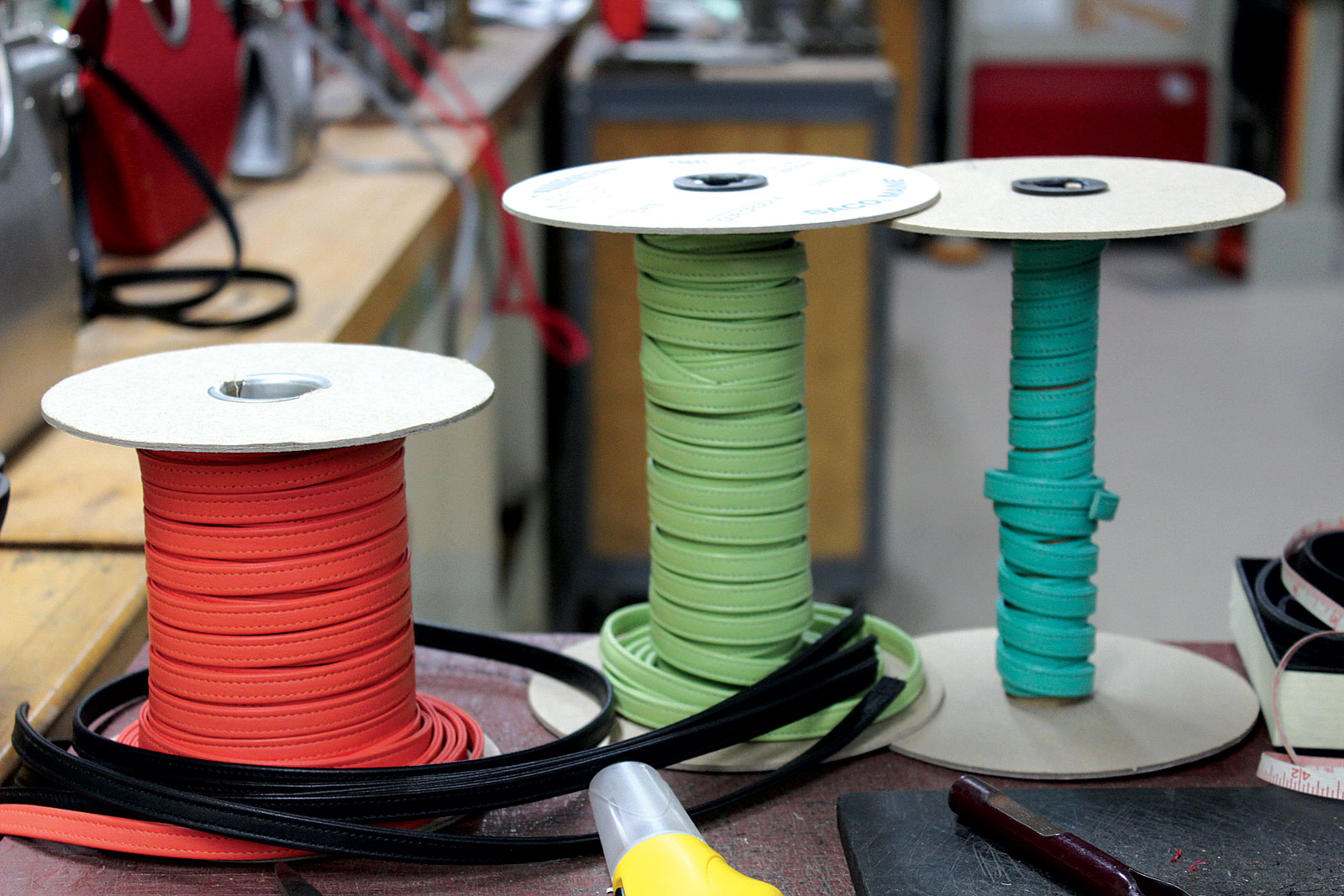 ROLLS OF LEATHER STRAPPING, stitched and ready to attach to bags. Photograph by Dariel Benton-Updike. 