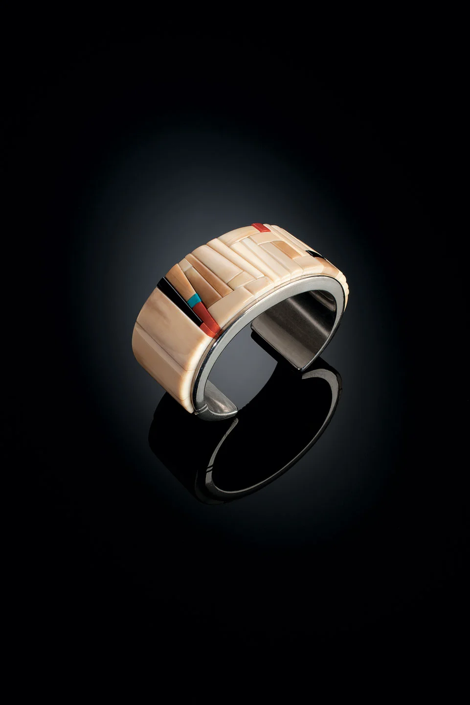 BRACELET of fossilized walrus ivory, turquoise, coral, black jade, and silver, 3.2 centimeters wide, 2012. Private Collection.