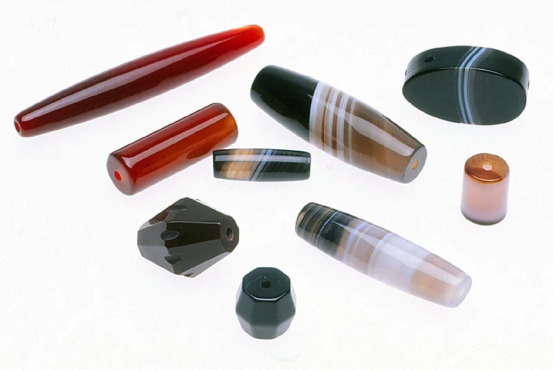 Array of vintage carnelian and agate beads, with colors enhanced by their makers, from Idar Oberstein in Germany. Note the precision of these wheel ground beads, with blanks usually cut by core drills. RKL
