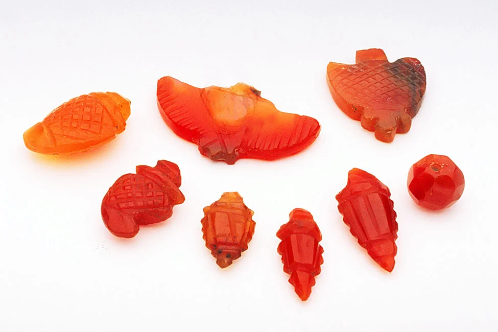 Old or vintage Indian made small carnelian bead and pendants, with much lapidary grinding. RKL