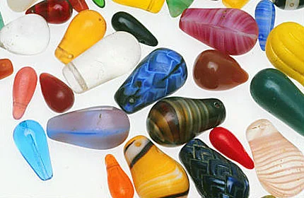 Assortment of vintage European press/molded glass drop pendants of varying sizes, some simulating stone. RKL