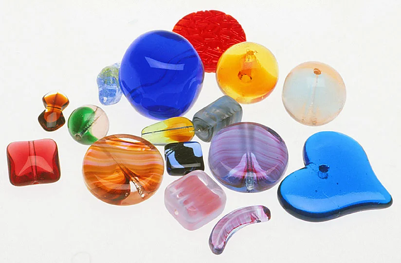 Array of European pressed glass beads and pendants. RKL