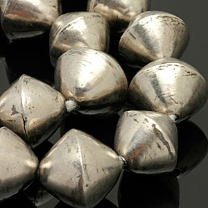 Large (approx. 2.5 cm) white metal bicones from Mali, Africa. CW