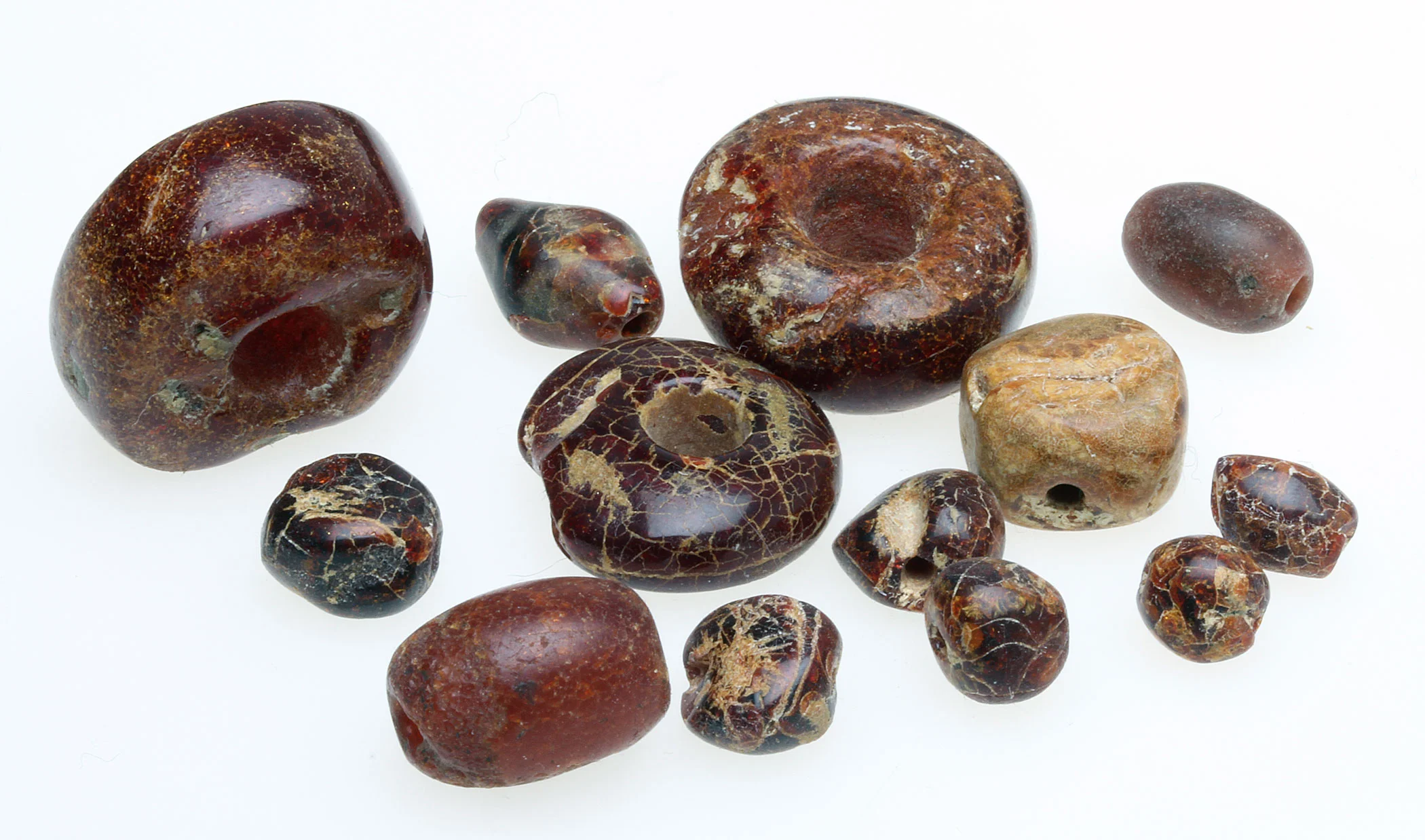 Ancient amber beads, note the extensive crazing. These have been treated with liquid nylon to strengthen them. RKL
