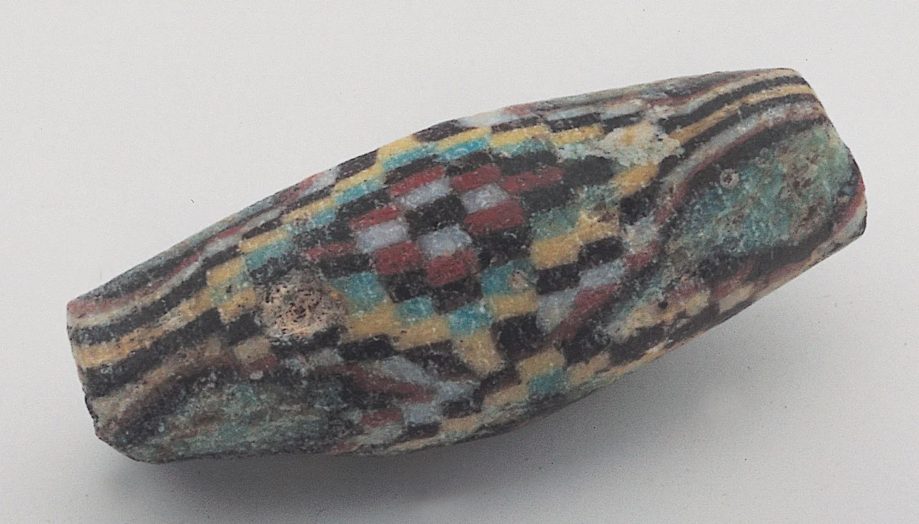 Chequer bead, ca. 100 BCE-100 CE, 2.2 cm long, weathered. Courtesy of Lost Cities. RKL
