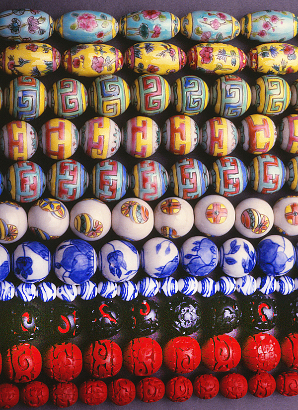 Contemporary Chinese porcelain and, on the last three rows, cinnabar beads. All are beads from the 1980s. RKL