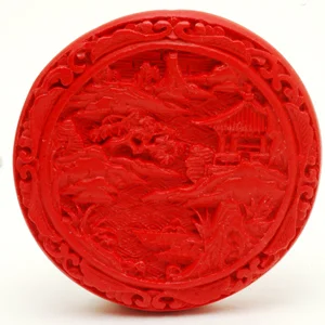 Detailed close up of contemporary large Chinese cinnabar bead. CW