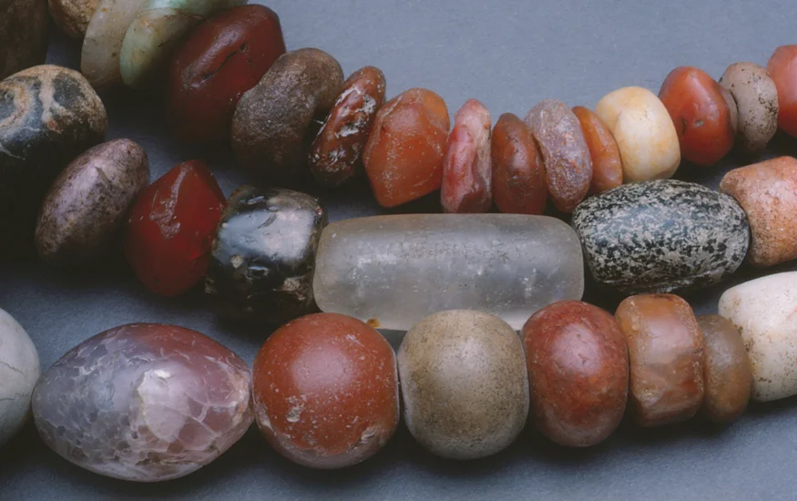 Carnelian beads from ancient Cambay, India, collected in Africa with some crystal and possibly indigenous granitic beads.