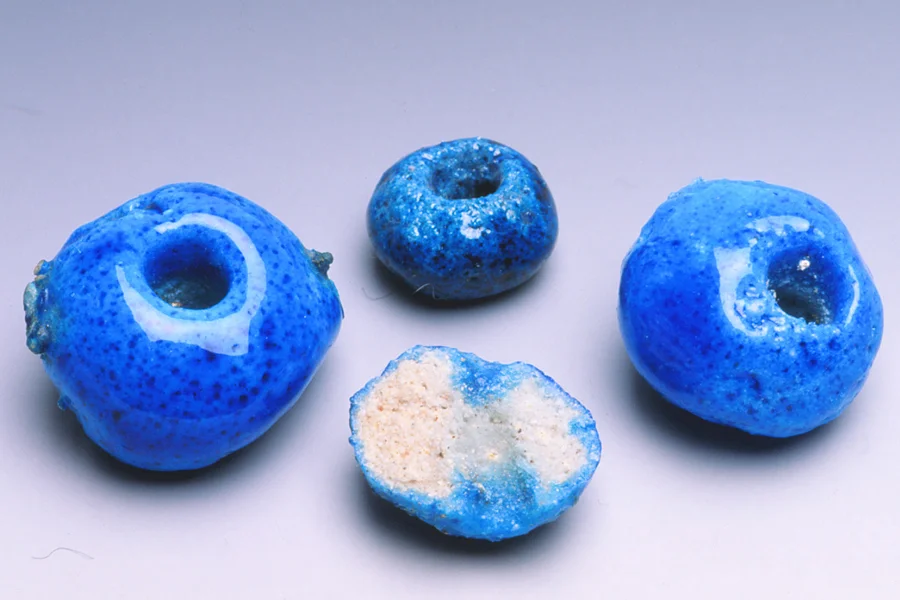 Contemporary faience donkey beads, made in Iran. The half bead shows that the glaze is only on the surface. RKL