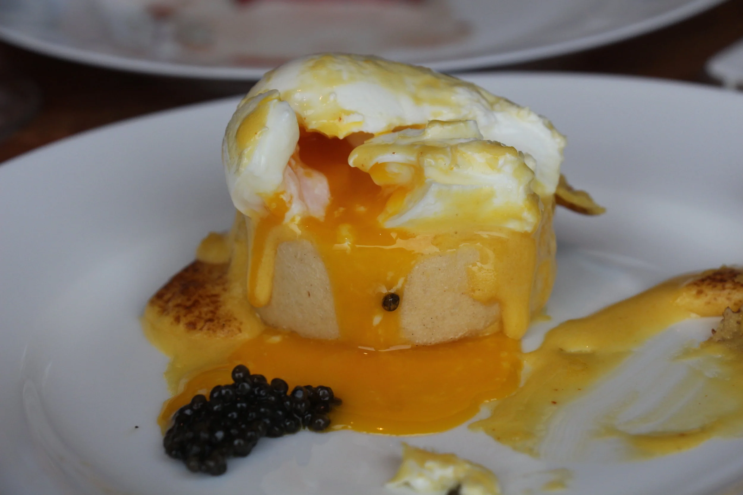 Creamy and dreamy hollandaise sauce over a perfectly poached egg atop a thick (just enough chew) English muffin, topped with caviar. A must order dish and a favourite order of mine. 