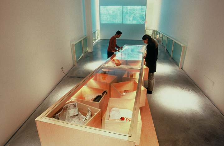  Visitors to the installation look through the top of the table section, through glass into the object boxes. The objects may be personal gifts or simply mementos of the experience. 