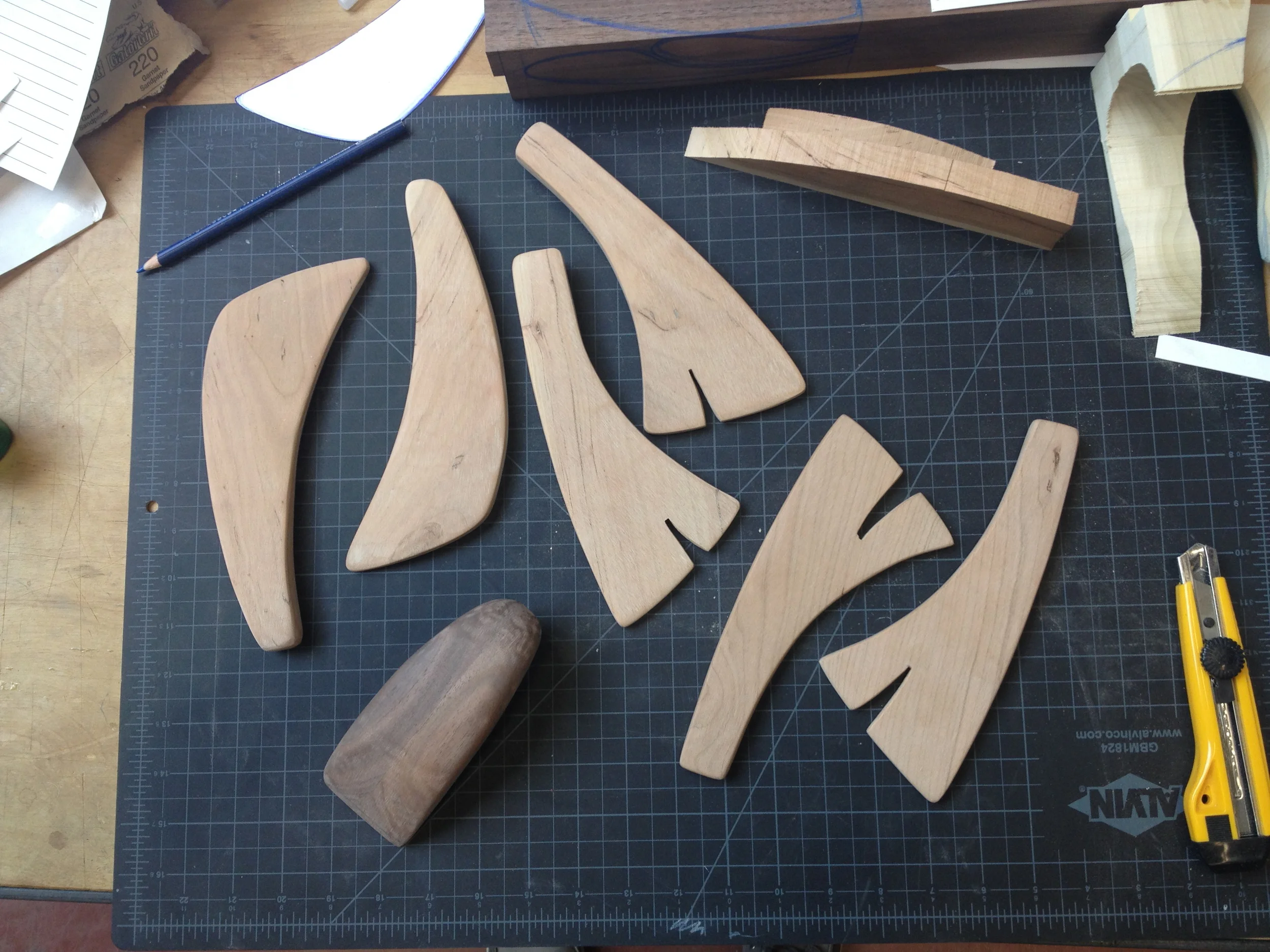 A few sets of salad servers and a dough scraper after being shaped and sanded, but before the natural beeswax finish is applied.