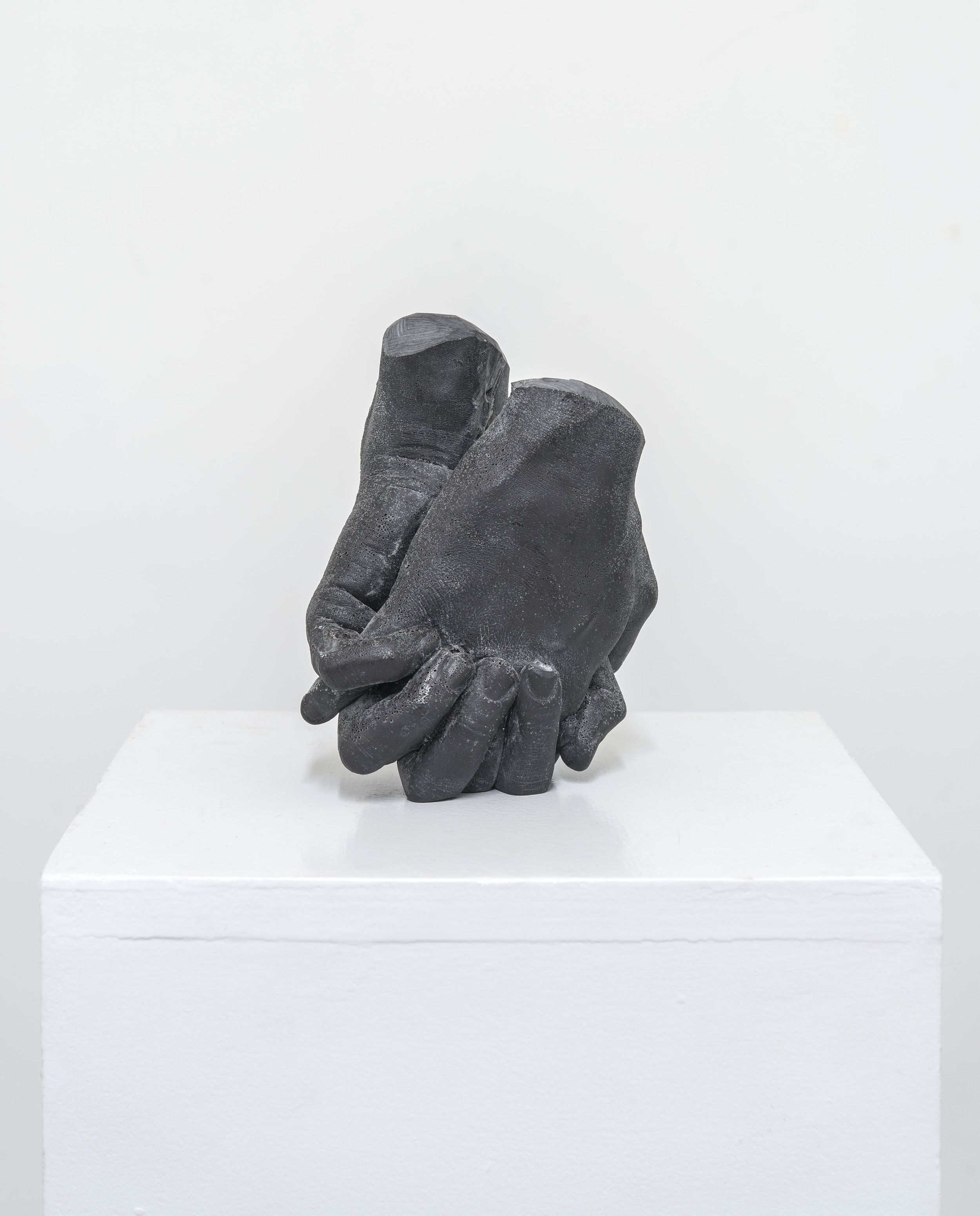 holding , 2017, cast graphite, 6-3/4 x 5-1/2 x 3”