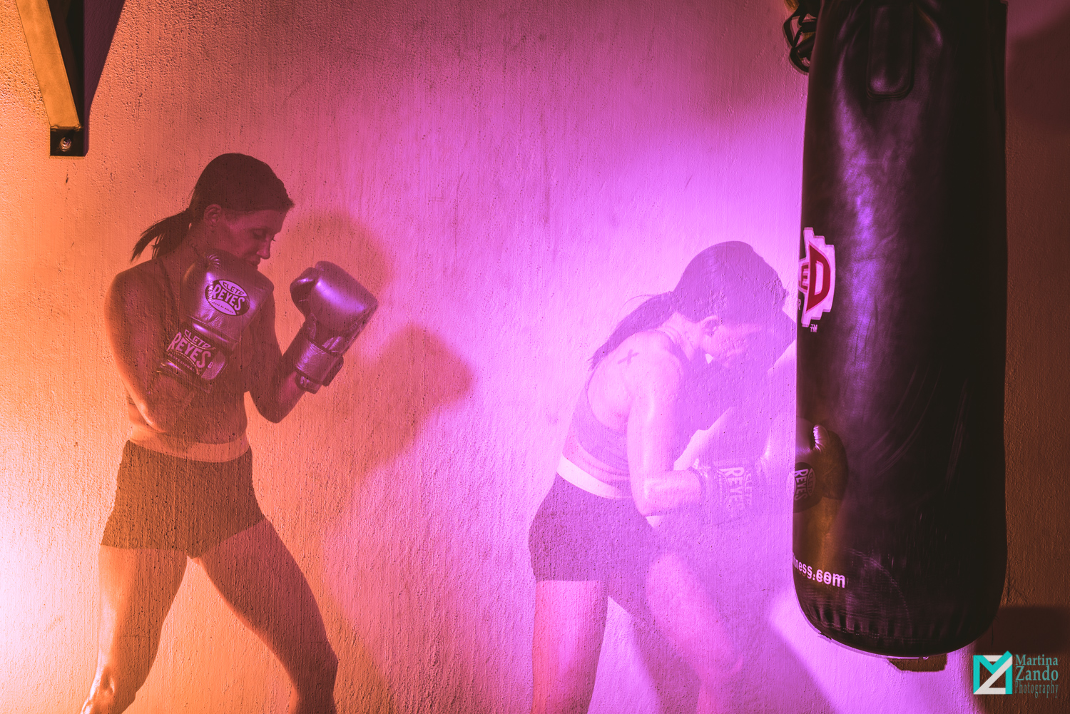 double exposure female boxer hitting bag 