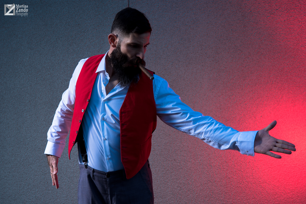 Tango and cigar with red backdrop and waistcoat