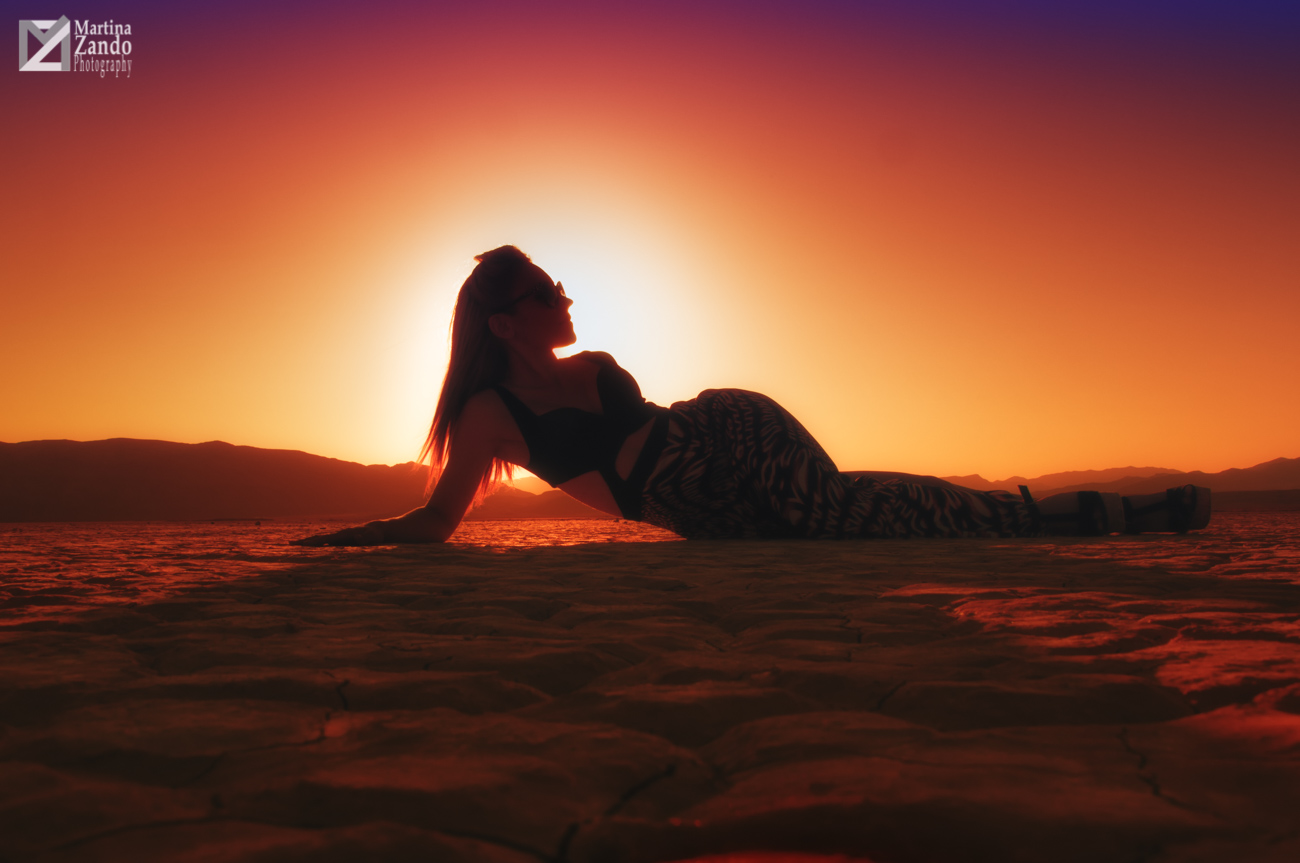 curves of woman in the desert at sunset