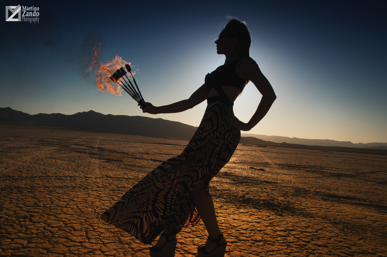 woman holding fire in the desert