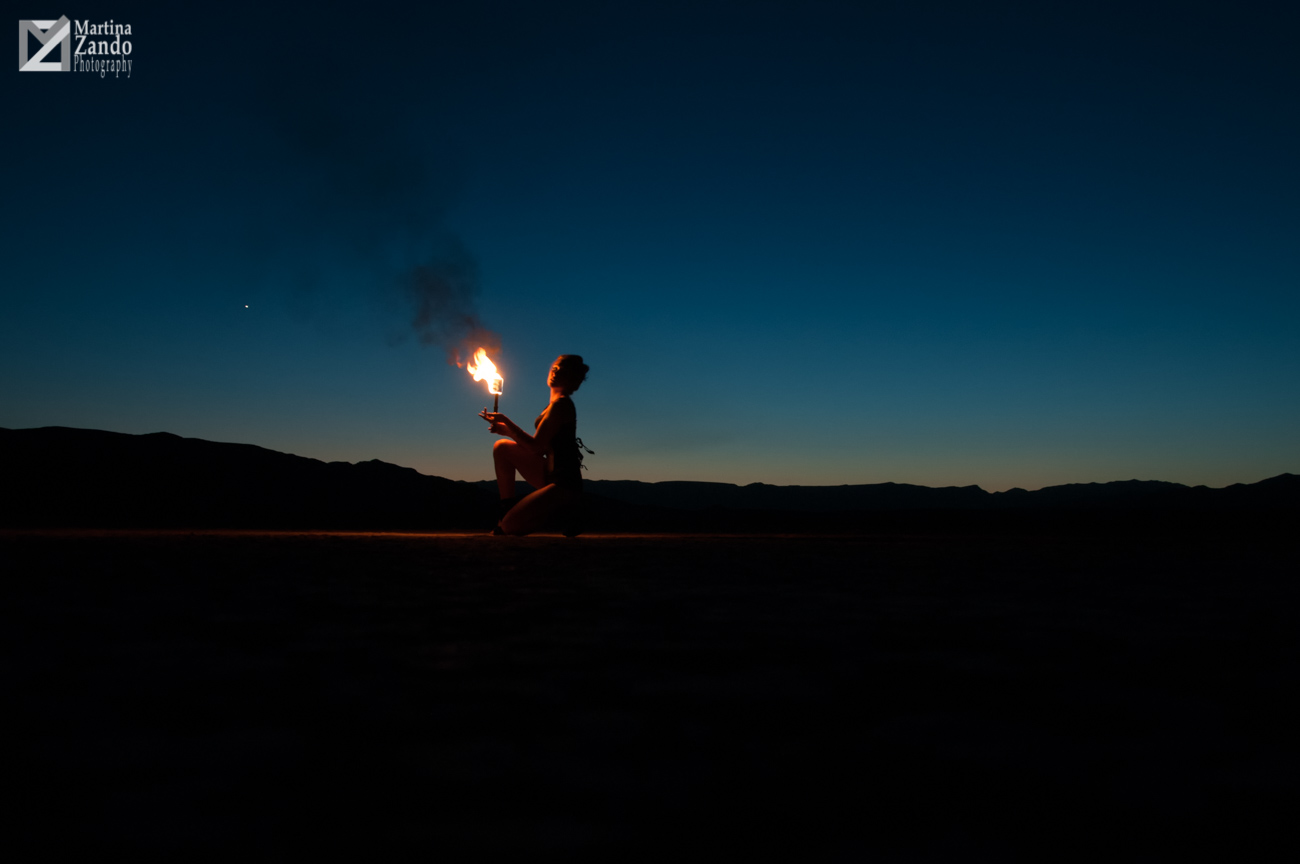 woman lit by fire in desert photoshoot