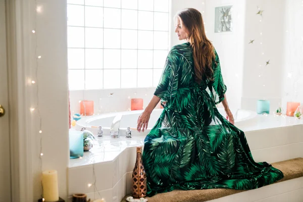 Boudoir Session in the bathtub, bright green robe with plants pattern. Photo by Martina Zando Photography 