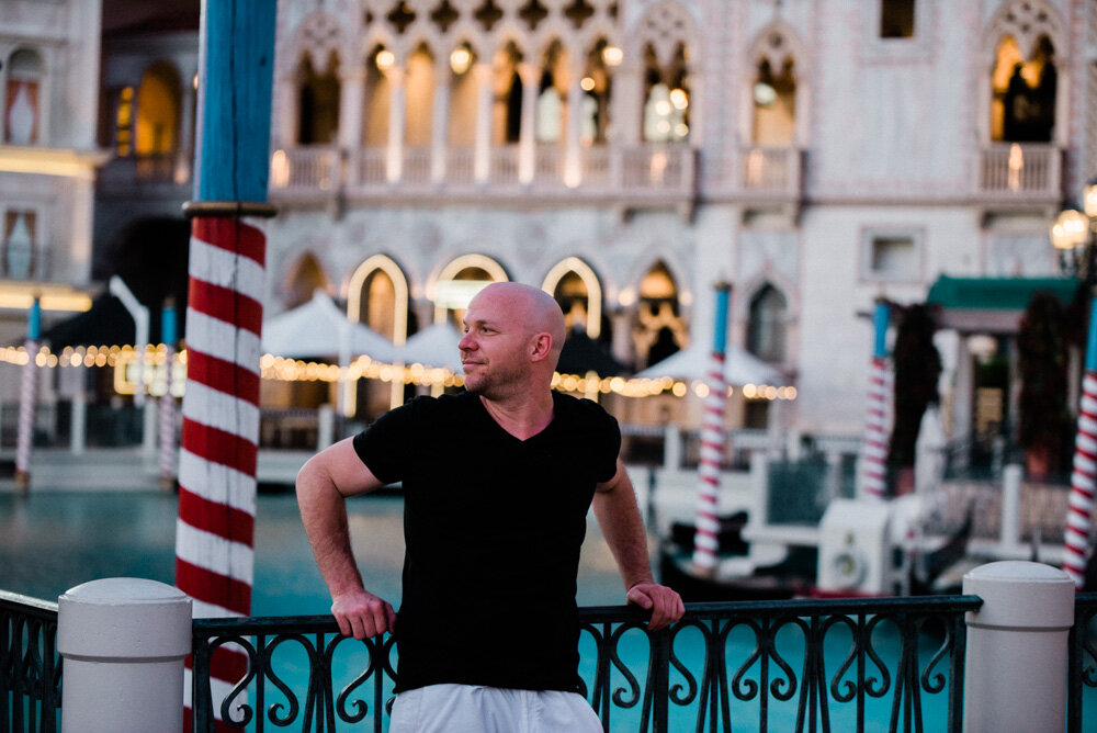 Man looking out by empty Venetian Hotel las Vegas during Lockdown