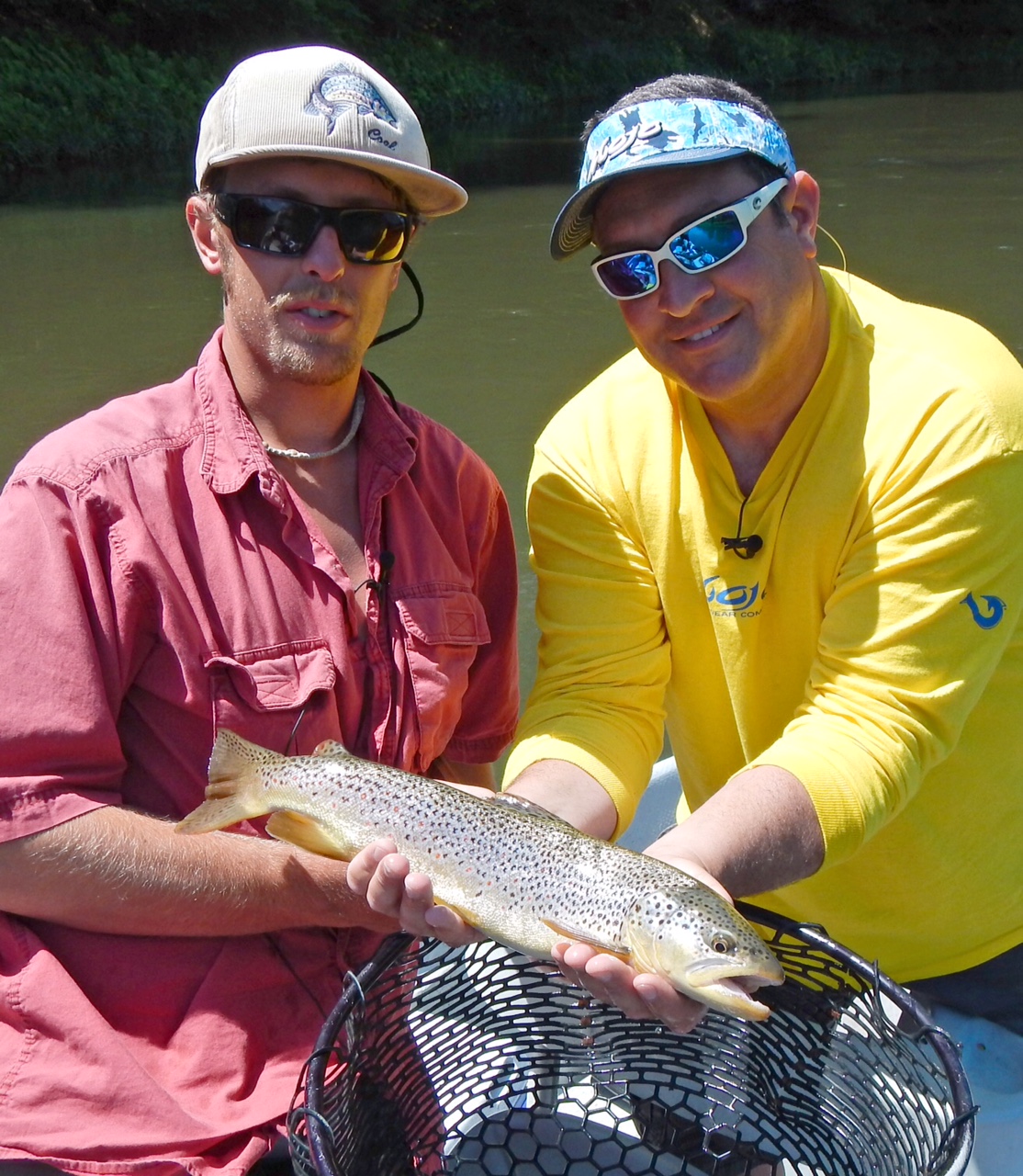 Capt. Joey leggio and Guide Evan P. display this 19" Brown trout