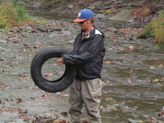 Guide Evan P. removing a tire from Shehawken Creek.