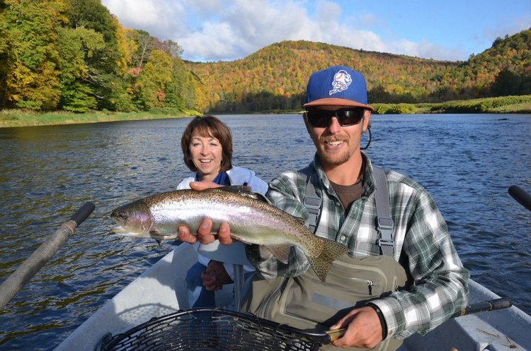 Guide Evan holding Sue's Wild Rainbow trout.