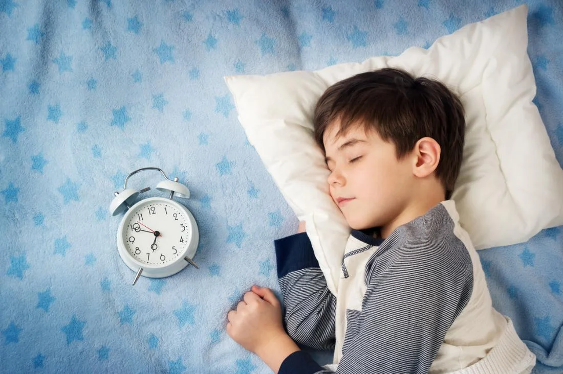 child-sleeping-with-clock.jpg