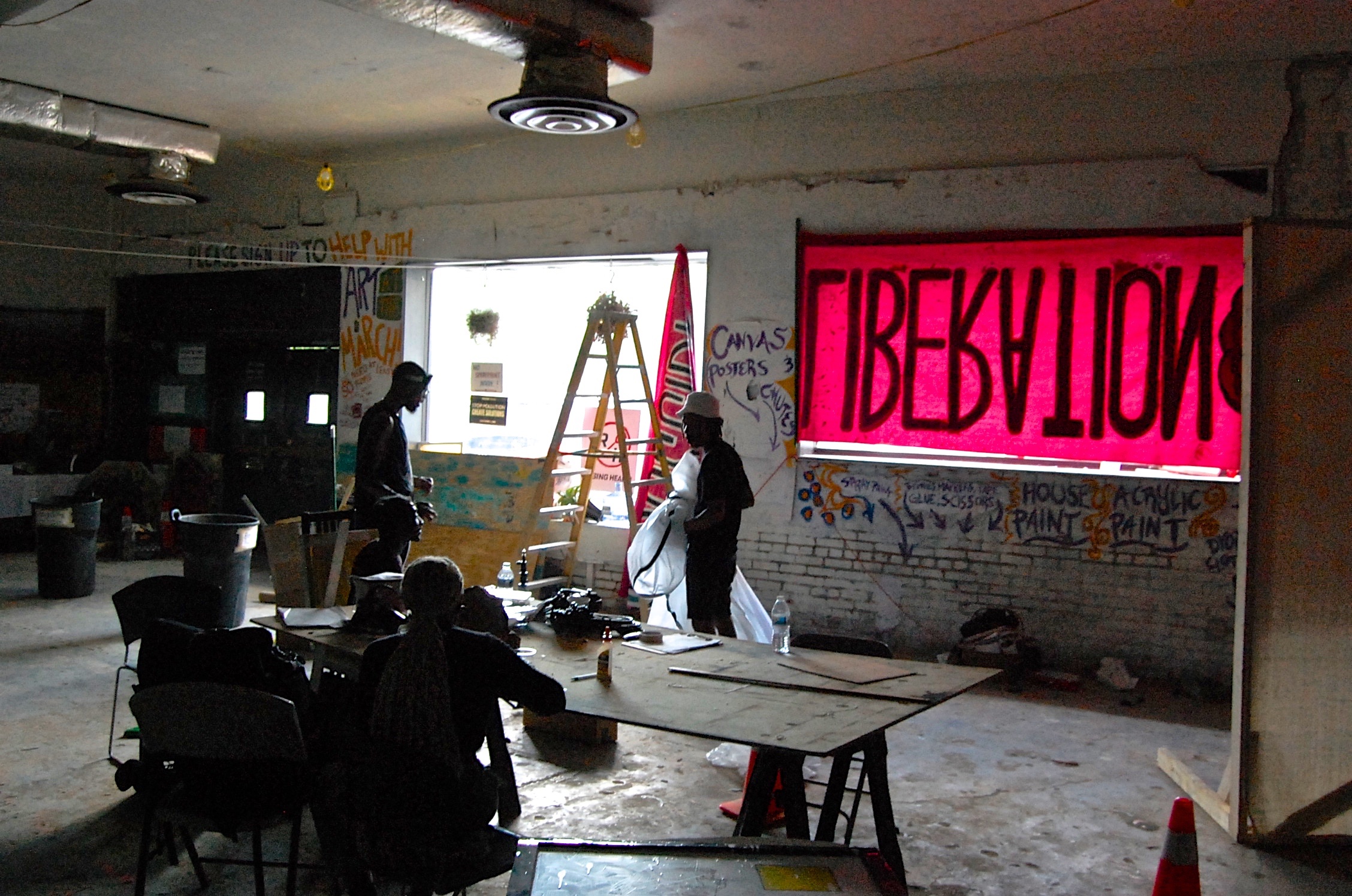 Jamal Gray, Parker Blair, and Marc Bryant begin set up for an event at Uptown Art House .