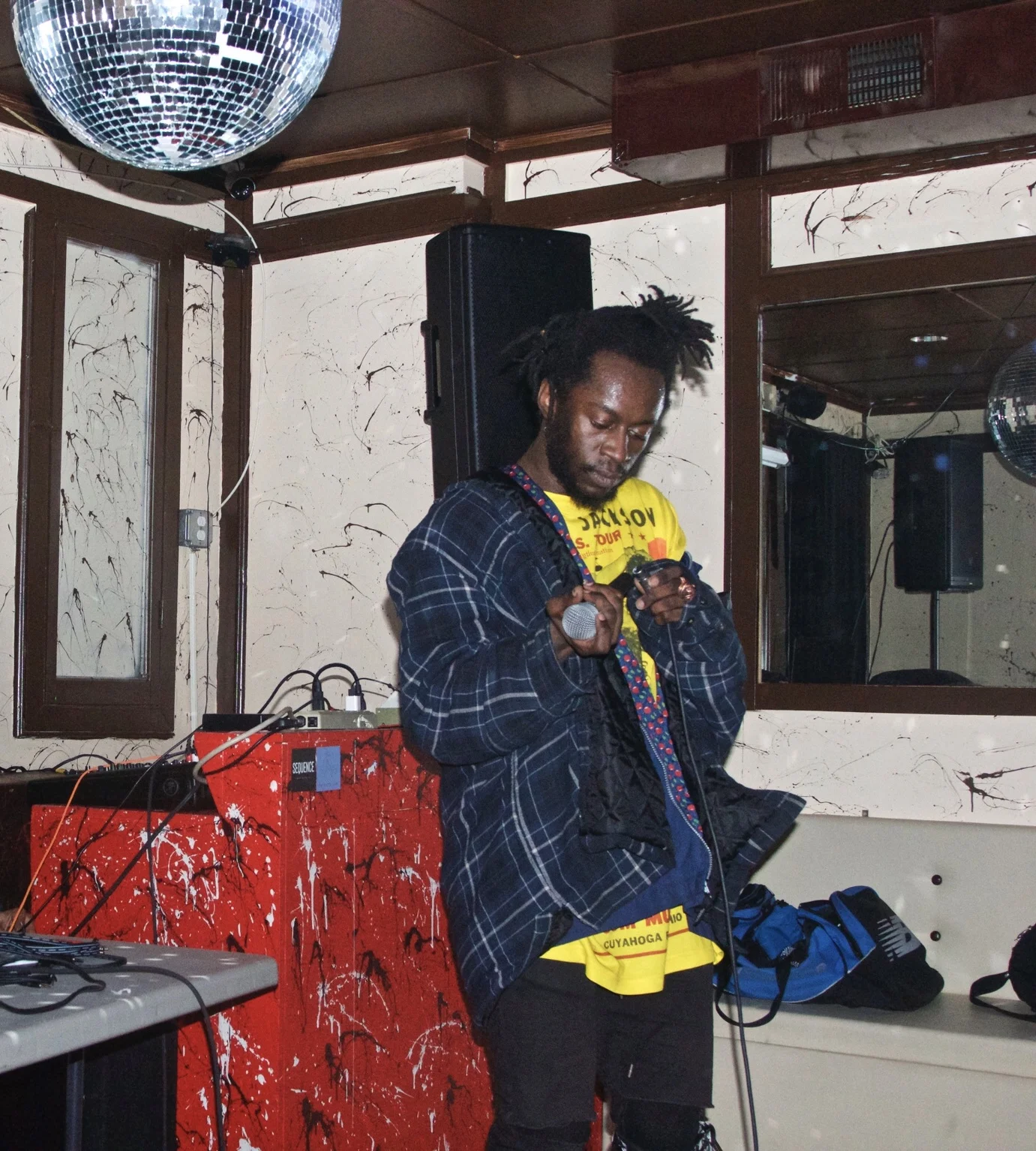 Sir E.U inspects the microphone at Studio Ga Ga . Photographs by Maxwell Young