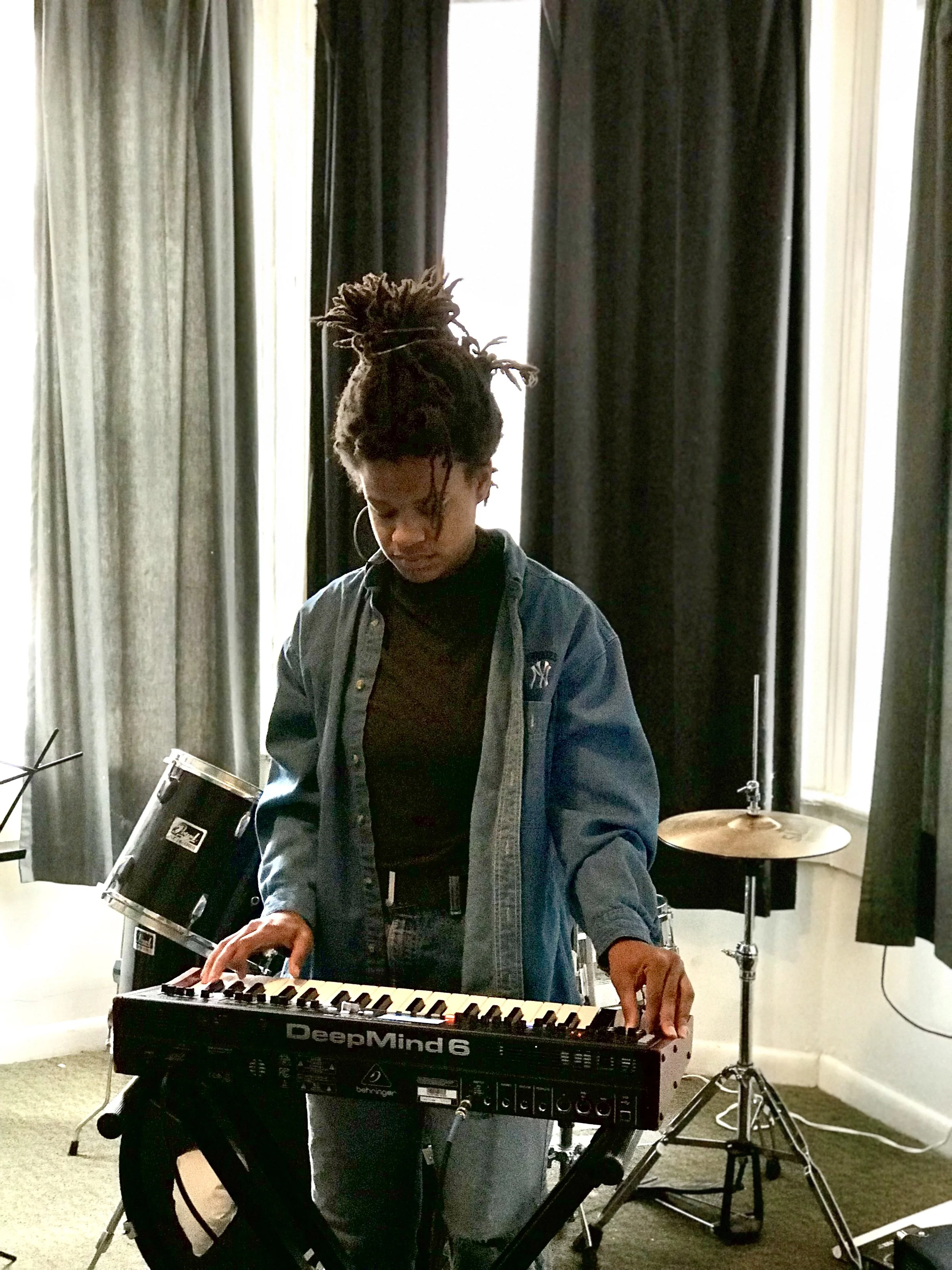 Jenna Camille tinkers with presets before she plays the keys. Photograph by Maxwell Young
