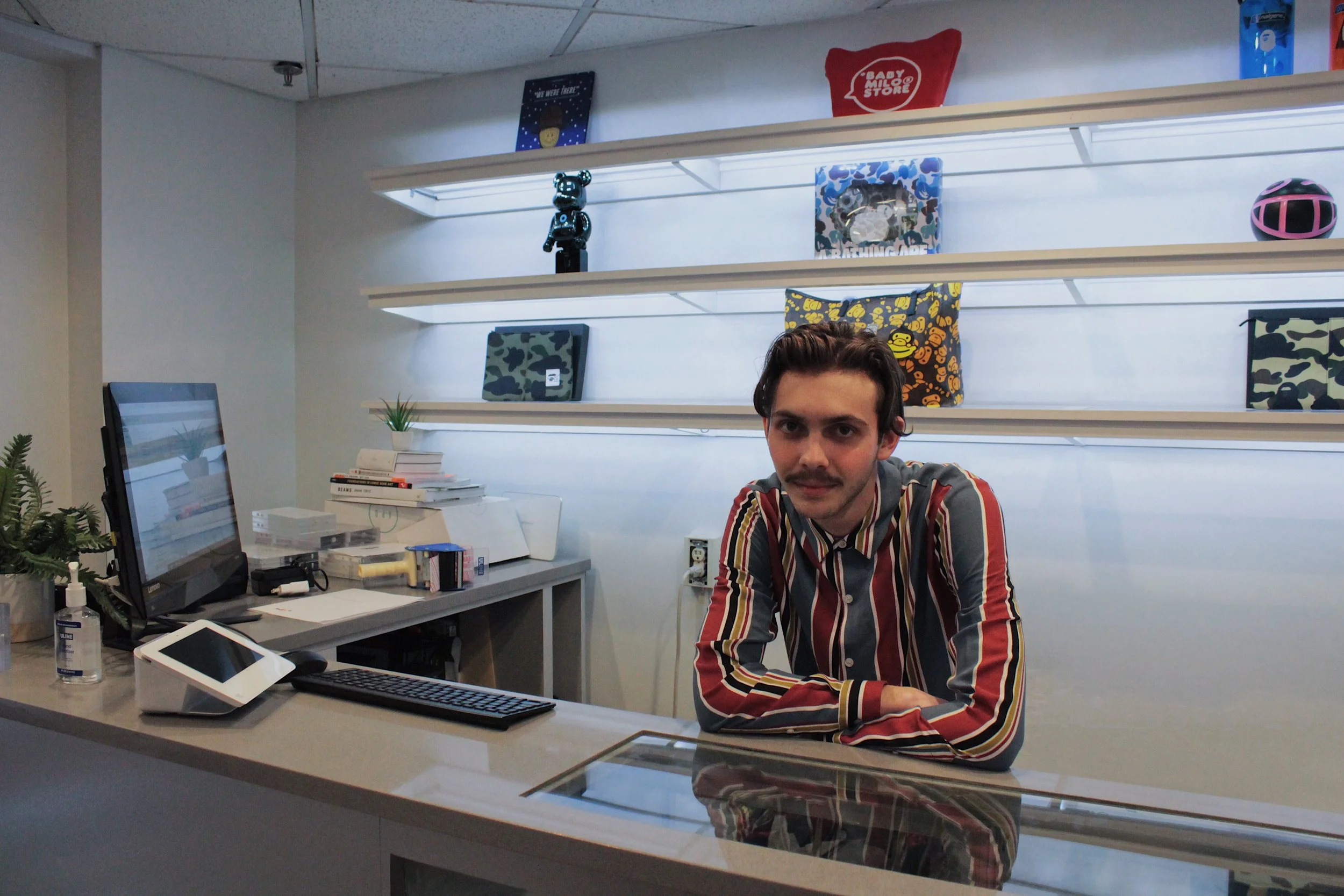 Tyler Calpin behind the sales counter at Social Status | photograph by Alex Young Read the transcript of Tyler Calpin’s interview below.