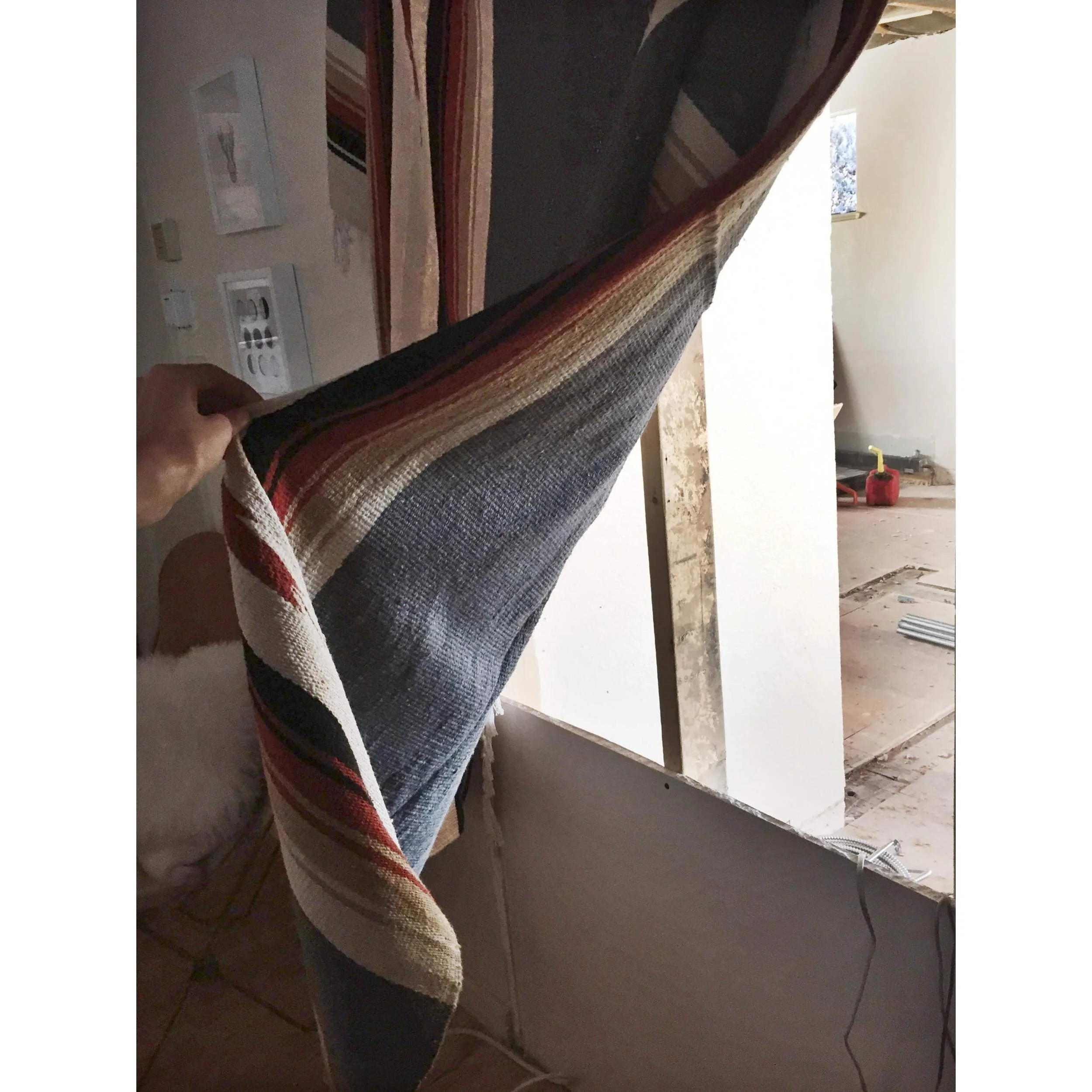 I wasn't kidding about the hole in our wall. Or the serape. See!