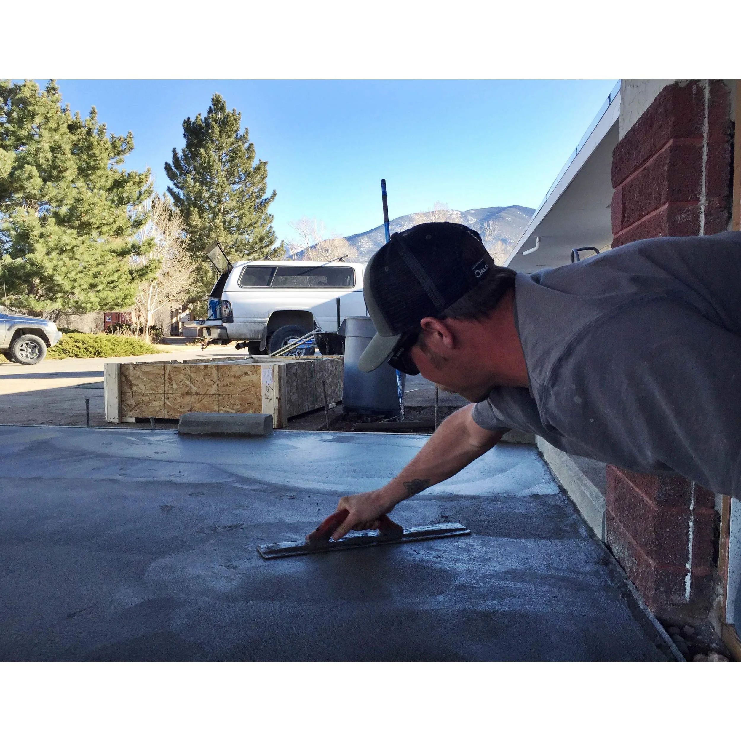Aaron, graciously smoothing the cement one more time after Moffet tracked paw prints all over the place!