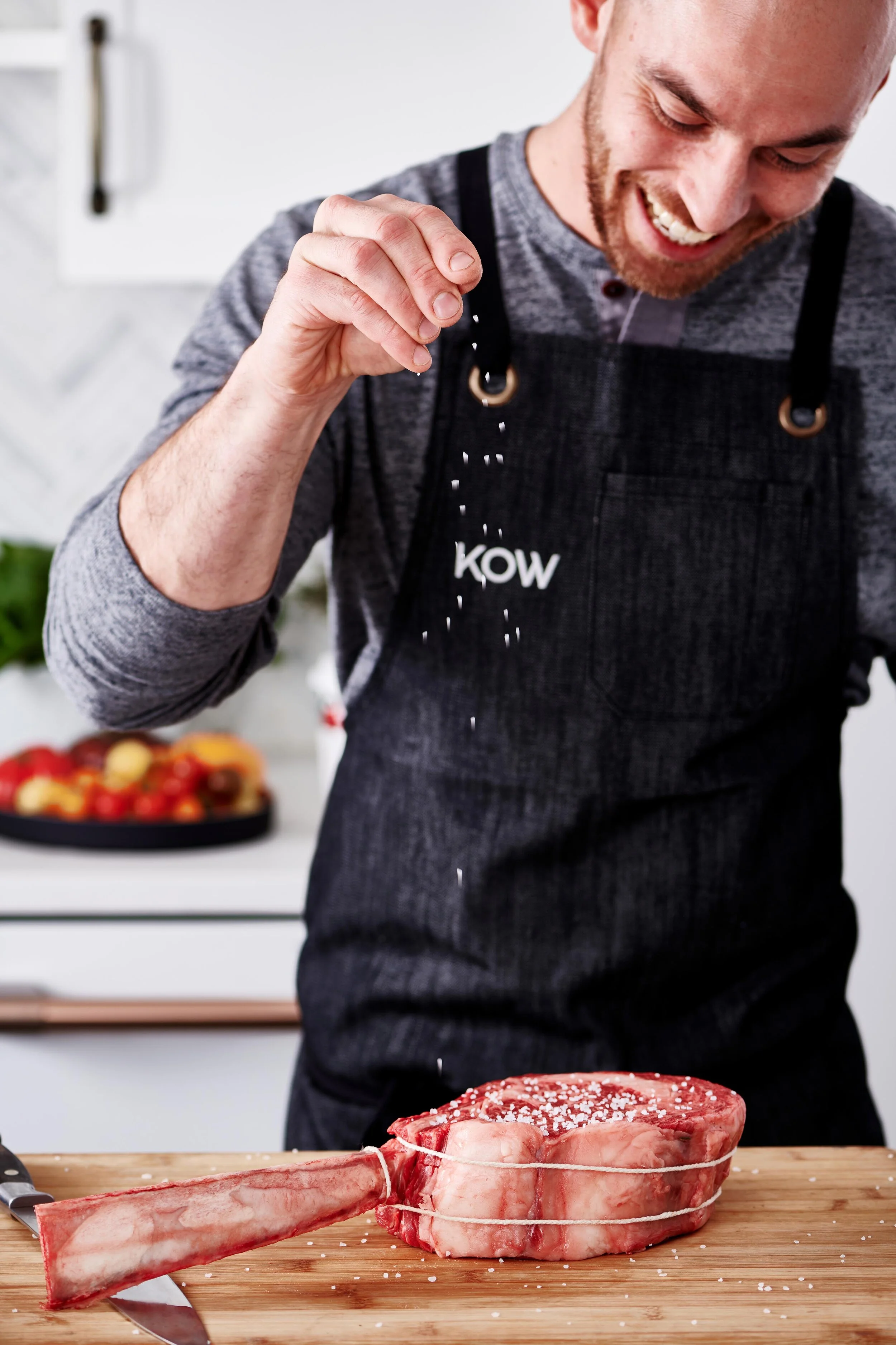KOW Steaks Salt Sprinkling in Kitchen